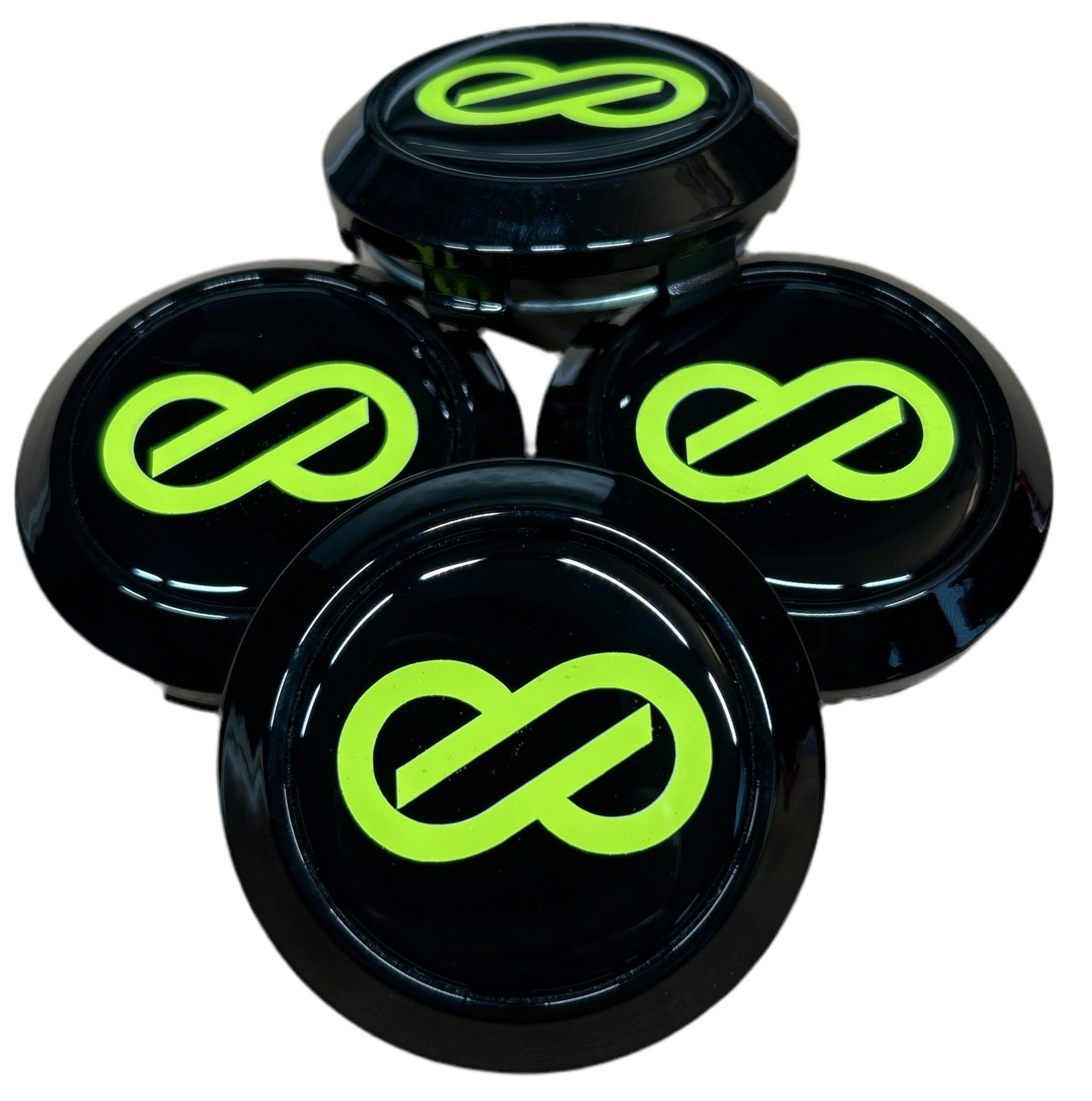 Four black wheel hub covers with green infinity symbol on a white background